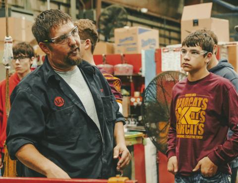 Webster Area High School freshman Mason Hauck, right, listens to Mereen-Johnson field service manager JP Vander Wilt, left, during a tour for high school students of the Mereen-Johnson’s facilities in Webster Oct. 3. Reporter &amp; Farmer | Leyton Beardslee