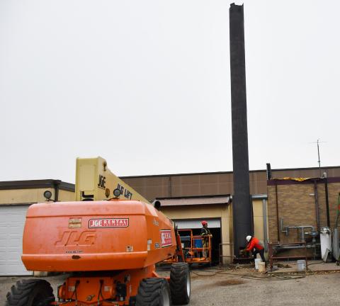 Demolition and dismantling of the Webster Area School boiler, smoke stack and flue started Nov. 5. Here, construction workers clear out debris from the large structure to ensure it is hollow in order to demolish it correctly. Reporter &amp; Farmer | Brenner Cariveau