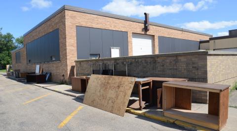 North of Webster Area High School July 17 sits surplus items as the north wing of the school will be demolished later this fall.