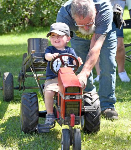 (At left) Weighing in at 19 months, Boone Lesnar of rural Webster takes his turn at doing the pedal tractor pull Aug. 9 during the Day County Fair. Lesnar is the son of Mike and Amber Lesnar. Russell Larson helps him along. Reporter &amp; Farmer | Amanda Dulitz