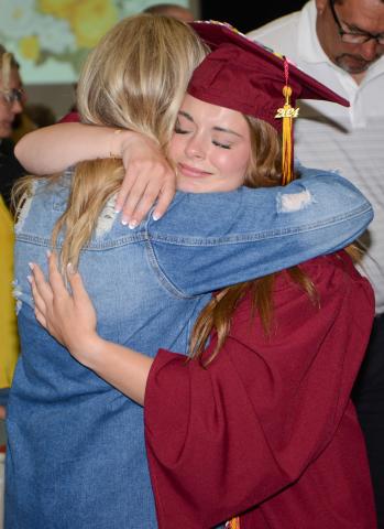 Webster Area High School graduate Charlotte Grewe shares an emotional moment with her mom Melissa Grewe May 19 during graduation proceedings at the Webster Armory where 32 graduates crossed the stage to receive their diplomas. Reporter &amp; Farmer | Amanda Dulitz