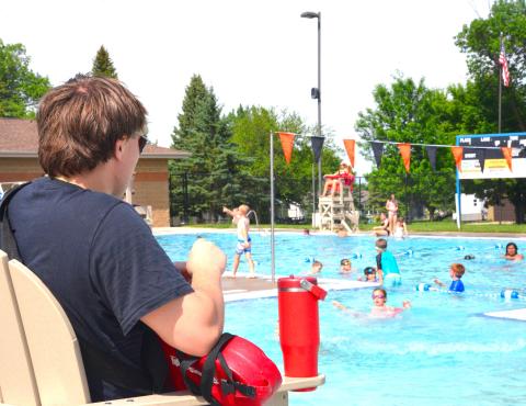 Thomas Kuecker, now with five summers of lifeguard experience, watches over swimmers in the afternoon sun on the first day of open swim at Webster Aquatic Center, June 1. Kuecker has made two rescues in his career, but said a typical day is spent enforcing the pool rules. Reporter &amp; Farmer | Timothy Gibson