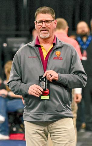 Webster Area head wrestling coach Wade Rausch receives his 25 year coaching award from South Dakota High School Coaches Association during SDHSAA State Wrestling Championships Feb. 27 in Sioux Falls. Rausch took the helm for the Bearcats starting in 2010 after a stint coaching for Ipswich Tigers and has announced his retirement from coaching will come at the end of the school year. Reporter &amp; Farmer | Brianna Jorgenson, Captured Creations Photography