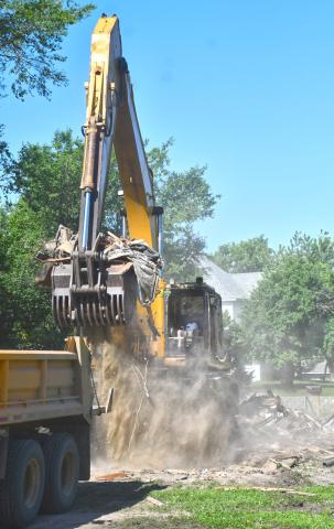Rubble from the demolition of a house located at 1106 Main St., Webster is loaded into a dump truck June 24. The demolition comes after the city seized possession of the property in August 2024 and the building caught fire in September of the same year. An investigation was launched to determine if the cause of the fire was arson but the states attorney ruled there was not enough evidence to pursue charges and the building was demolished. Reporter &amp; Farmer | Leyton Beardslee