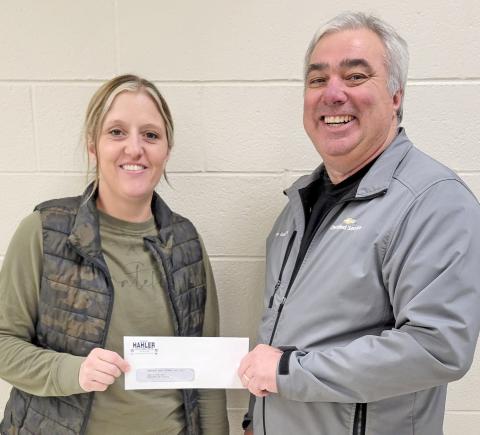 Webster Area School nurse Heather Gaikowski receives a check presented by Loren Schoenbeck on behalf of Dave Hahler Automotive in Webster Nov. 26. The $2,100 donation will to towards assisting students in need of winter clothing. Reporter &amp; Farmer | Subscriber snapshot