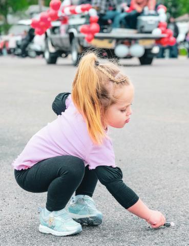 Cicily Duerre, three, of Bristol picks up some candy June 14 during a parade at the Roslyn Vinegar Festival. Festivities included vinegar tasting, music, a dance performance and the coronation of the Vinegar Queen. Reporter &amp; Farmer | Leyton Beardslee