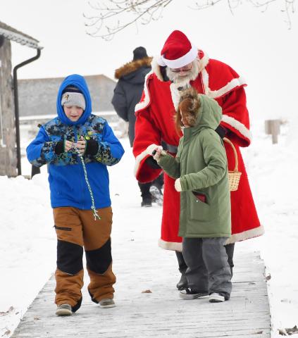 Santa visited Fort Sisseton Historical State Park distributing candy to children during the Frontier Christmas celebration Dec. 14. Here, from left 12-year-old Elias Lindner and 10 year-old Eliana Linder from Watertown walk away after Santa handed out candy to them. Elias and Eliana are the children of Dana and Jamie Lindner. Reporter &amp; Farmer | Brenner Cariveau