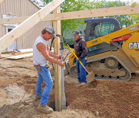 Rock is stamped around posts May 28 as construction begins for an addition to the Museum of Wildlife, Science &amp; Industry in Webster. Pictured from left are Chris Amundson and Greg Johnson. Reporter &amp; Farmer | subscriber snapshot