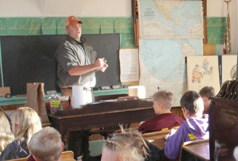Calvin Meyer of SD Game, Fish &amp; Parks led Webster Area fourth graders in creating pollinator balls of clay and seeds. Reporter &amp; Farmer | Subscriber snapshot