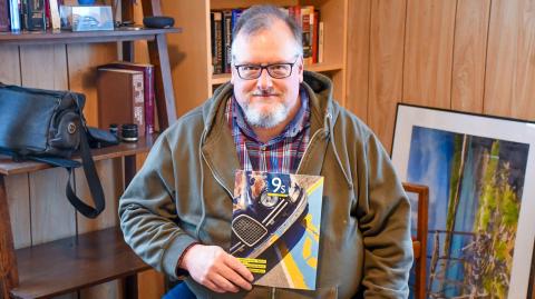 Greg Abbott of Lily, pictured in his home Dec. 10 is the chief editor of the Saab Club of North America’s quarterly magazine. Abbott said he purchased his first of many Saab cars while in college and has been involved with the club since 2006. Reporter &amp; Farmer | Leyton Beardslee
