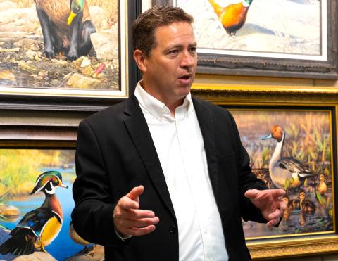 Adam Grimm, surrounded by his artwork, talks to attendees of his hometown celebration in Wallace Aug. 9 about winning the 2024-2025 Federal Duck Stamp Art Contest. This was Grimm’s third time winning the contest but first time holding a celebration in Wallace which included bouncehouses, educational games, coloring contests and displays of Grimm’s art. Reporter &amp; Farmer | Leyton Beardslee