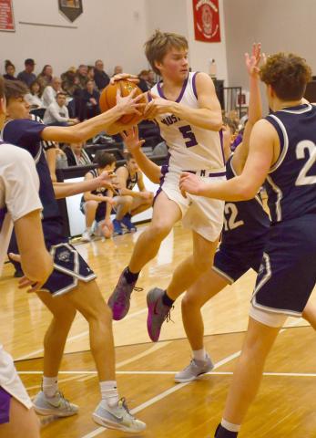 Waubay-Summit Mustangs faced off against Great Plains Lutheran Panthers Feb. 20 in Summit which ended in a 57-47 victory for the Mustangs. Here, Dylan Rumpza (5) attempts to distribute the ball while a claw of Panthers surround him. Reporter &amp; Farmer | Brenner Cariveau