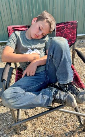 It was a long, tiring weekend, as illustrated by 4-Her Logan Wik who fell asleep during the premium sale at the Day County Fair Aug. 10. He is the son of Shawn and Jessica Wik. Reporter &amp; Farmer | Subscriber snapshot