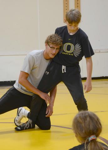 Webster Area 2022 graduate Cael Larson demonstrates a move on incoming Webster Area eighth grader Vance Tollifson. Webster Area Wrestling Booster Club hosted the camp for wrestlers sixth grade and under, Thursday July 24 at the wrestling room. Following the camp a summer party took place at Webster Aquatic Center. Reporter &amp; Farmer | Annie Witt