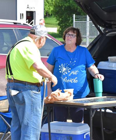 The first day of Webster’s farmers market was June 2 and people were set up and ready to sell their creations. Here, Danny Johnson buys salads from Betty Schmidt. “It is the world’s best salads,” said Johnson. Reporter &amp; Farmer | Connor Handrahan