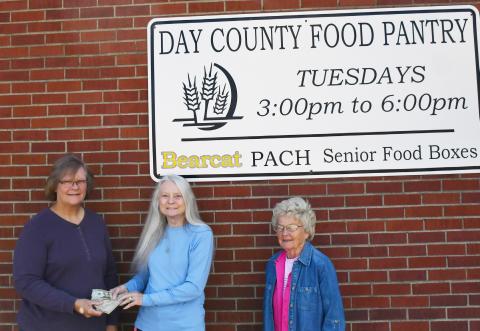 The Day County Food Pantry received a donation of funds from the first annual Chuck Aleck Memorial event. The memorial event was conducted by Bondell Raeder-Aleck Sept. 15 and saw contributions from attendees which totaled for over $1,300 in cash and giftcards. Here, on the left Margaret Kwasniewski is given the funds received from Raeder-Aleck and to the right is Carol Richardt.