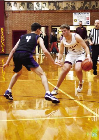 Webster Area Bearcats hosted the Waubay-Summit Mustangs in a game the Bearcats dropped 44-45 Dec. 17. Here, Webster Area guard Ian Lesnar (5) looks to escape the on ball pressure of Waubay-Summit’s Tigh Gaikowski (4). Reporter &amp; Farmer | Brenner Cariveau