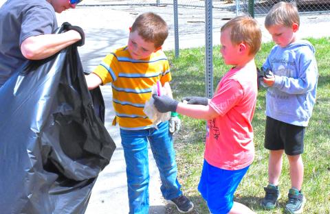Earth Day was April 22 and Webster Area Elementary School honored this day by going outside to clean up dirty areas near the school. From left, Ridge Neuberger, Xavier Wegleitner and Garrett Curran help clean up the back of the school and help save the world one piece of trash at a time. Reporter &amp; Farmer | Connor Handrahan