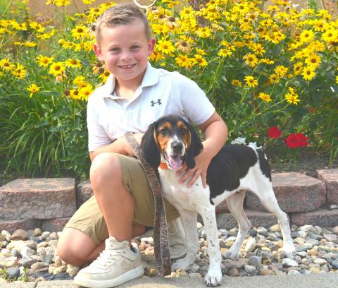 Seven-year-old Theodore Ure of Webster holds Cooper, the Walker Coonhound puppy he won through the Great American Hound Puppy Giveaway. Ure traveled with his father Jake to Wyoming to pick up Cooper and looks forward to training and hunting with his new best friend. Reporter &amp; Farmer | Timothy Gibson