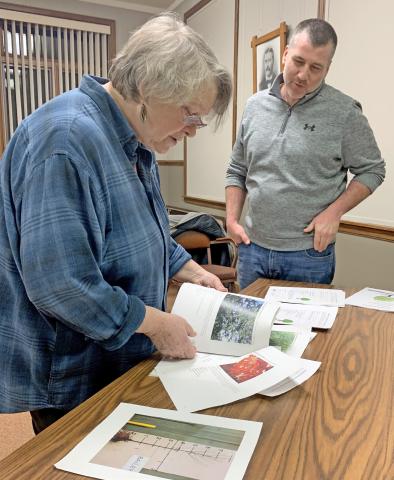 Webster resident Susan Brazda looks over some printed information about different tree varieties available for planting in 2025 through the new tree planting pilot program geared towards diversifying Webster’s urban forest during a public information meeting Dec. 10 at Webster City Hall. Josh Wagner of the Day County Conservation District, stands by to answer questions. Reporter &amp; Farmer | Amanda Dulitz