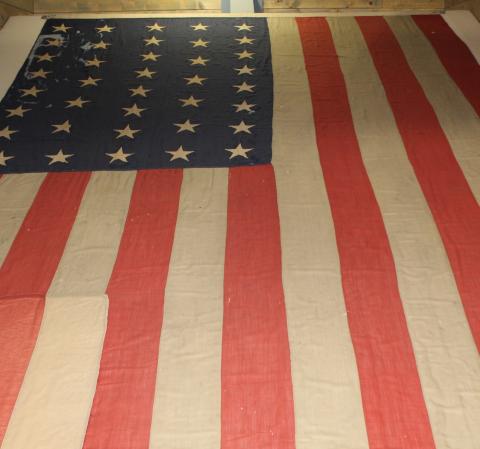 The flag that flew over Fort Sisseton in its final days as a military post lies on display inside the Historic Park’s visitor center. Over 130 years old, the tattered flag was restored by dozens of volunteers, yet these stars and stripes remain imperfect and beloved – like the nation it represents. Reporter &amp; Farmer | Timothy Gibson