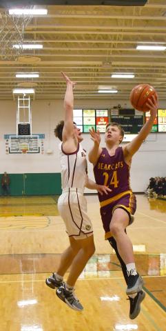 Webster Area boys basketball faced Milbank in Aberdeen March 4 in the first round match of the Region 1A bracket. Bearcats went on to lose the contest 20-54. Here, McKoy Pereboom (24) drives to the basket while Milbank defender Bryan Meyer (4) attempts to block the shot. Reporter &amp; Farmer | Brenner Cariveau