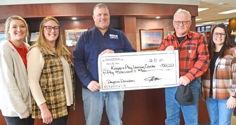 Members of the Knapp &amp; Play Learning Center committee, from left, Lexi Rithmiller and Jenna Wik received a check presented by Joel and Roger Shoemaker Feb. 11. Also pictured is Rainy Hanson with the Webster Area Development Corporation. The Shoemakers made a $50,000 donation towards the Webster childcare center on behalf of their business, Webster Scale. Reporter &amp; Farmer | Amanda Dulitz