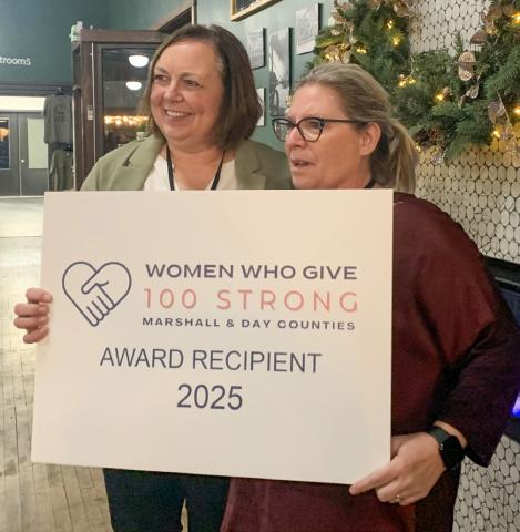 Jennifer Roerig presents the top 100 Strong of Marshall and Day counties award to Marie Marlow of the Marshall County Food Pantry during the first annual Women Who Give event Dec. 2 held in Webster. Five non-profits were in the running for the top prize, this year equating to $9,000. Each of the other four charities received $925. In total, the event saw 117 women register and raised $12,700. See more: 14. Reporter &amp; Farmer | Amanda Dulitz
