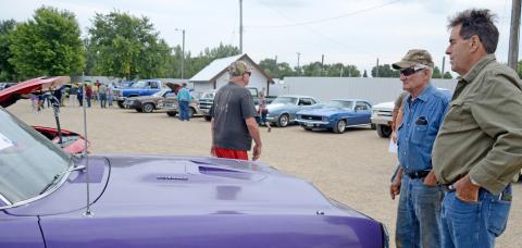 During the Day County Fair Aug. 10, numerous classic cars were on display for the public to view. Here, Roger Pesall and Carl Pulvermacher look at and talk about a classic Dodge Dart 383 Magnum as others walk around in the background. Reporter &amp; Farmer | Amanda Dulitz