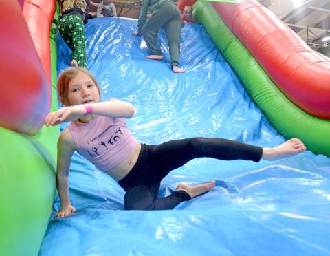 Nine-year-old Olivia Ewing bounces on one of the inflatable game areas that was at the Shake Your Shamrock event at the Webster Armory March 15. The event was used as a fundraiser for the Webster-Dewangen student exchange group. Ewing is the daughter of Corey and Ashley Ewing, Webster. Reporter &amp; Farmer | Amanda Dulitz