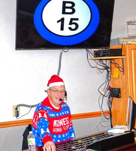 Royce Birney rolls and announces bingo numbers at Waubay Senior Center’s Christmas celebration Dec. 6. Community members celebrated the holiday season with bingo, food, seasonal activities and Santa, Mrs. Claus, The Grinch and Cindy Lou Who meet and greet. Reporter &amp; Farmer | Connor Handrahan