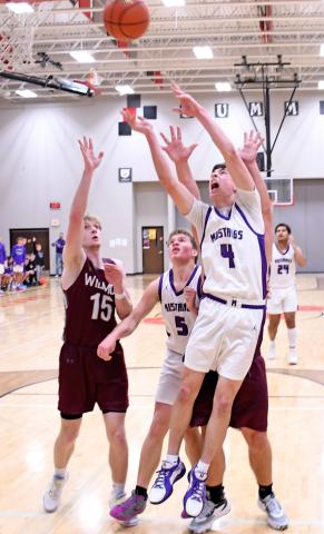 Waubay/Summit Mustang Tigh Gaikowski (4) pushes his way past a couple of Wilmot Wolves Jan. 11 to attempt a basket while Mustang Dylan Rumpza (5) looks on. The Mustangs hosted the Wolves in Summit running away with the victory 61-28. Reporter &amp; Farmer | Robert Dulitz