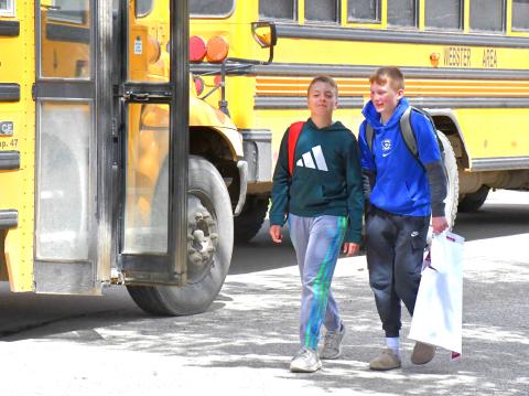 From left, Gunnar Lesnar and Decker Huggett joke and laugh as they walk out of Webster Area School on the final day of school May 18. Reporter &amp; Farmer | Connor Handrahan