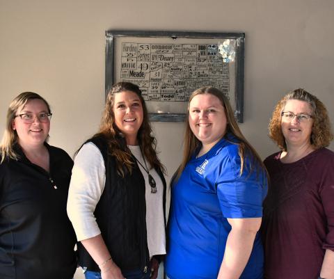 Standing in the Roerig Insurance office lobby are Webster team members Brooke Smidt, Katy Marx, Kayla Kirchmeier, Amy Fischer.