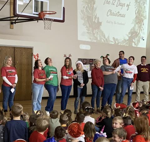 Webster Area Elementary School staff and students took part in a Christmas sing along in the elementary school gym Dec. 20. Staff, from left, leading the singing of The 12 Days of Christmas are Vanessa Bloom, Robin Dorsett, Jennifer Witt, Ashley Hanson, Christine Keller, Nancy Block, Heather Kwasniewski, Jared Vergeldt, Emily Wagner and Wade Rausch.