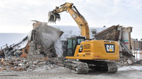 An excavator demolishes the 1950s wing of Webster Area High School Dec. 2. The demolition comes after the school’s insurance company pressured the school with a non-renewal notice to either fix or demolish the wing because of structural concerns. Reporter &amp; Farmer | Leyton Beardslee
