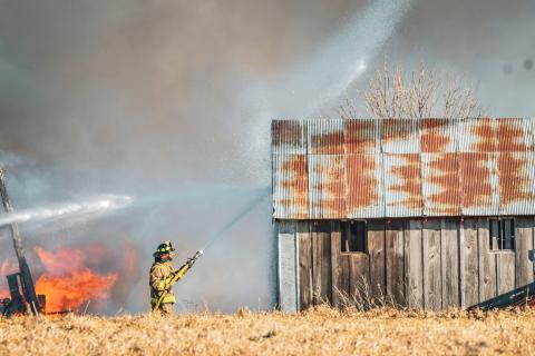 Second assistant fire chief Chris Gravley of Webster Fire Department sprays down a building to keep flames from spreading after a barn fire broke out at 14308 423rd Ave. south of Bristol Jan. 15. Additional details about the fire will be available in next week’s issue. Reporter &amp; Farmer | Leyton Beardslee