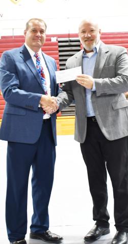 As a Veterans Day celebration was held Nov. 11 at Webster Armory, numerous events took place including choirs, essays and a military ceremony. Here Webster Area School Superintendent Jim Block left shakes hands with Jeff Nelson, Day County Veterans Service Officer after presenting a check worth $700 as the Veterans Day event ended. Reporter &amp; Farmer | Brenner Cariveau