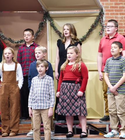 Webster Area elementary students k-6 participated in the winter concert Dec. 9 at the Webster Armory. Here, in back from left, fourth grade students, Gunnar Lesnar, Izzy Treece, Graysen Dean; in middle row from left, Kori Gaikowski, Grant Sinner, Emerie Schlechter, Matthew Sichmeller and in front Luke Sichmeller find their vocal range during the performance. Reporter &amp; Farmer | Brenner Cariveau