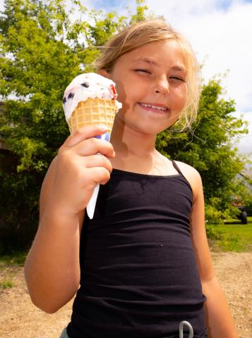 Naomi Lesnar, age eight, daughter of Marlaina and Christopher Kinn from Grenville holds up her ice cream cone July 19 at Waubay Fun Fest. The festival ran July 18-20 and included events such as a cornhole tournament, live music and a parade. Reporter & Farmer | Leyton Beardslee