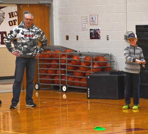 Neenah High School hosted a fishing learning day at Webster Area Elementary and Middle School Feb. 26, where students were taught fishing techniques. From left, David Sonnabend and right, Matthew SIchmeller practice casting their fishing rods. Students took turns using the fishing rod and tried to catch the plastic fish. Reporter &amp; Farmer | Connor Handrahan