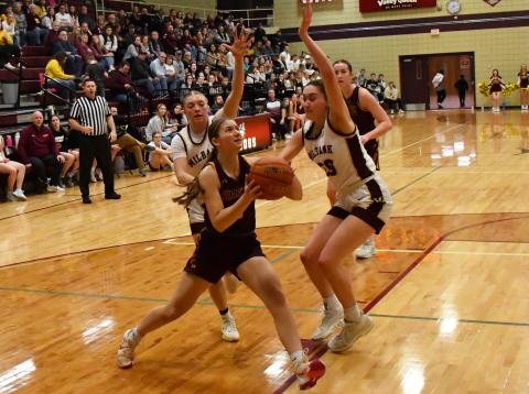 Webster Area girls basketball traveled to Milbank to face the Bulldogs in a first round matchup in the 1A regional bracket which Webster Area lost 28-63. Here, Chloe Mammenga (5) atempts to drive past Milbank defenders Isabella Anderson (5) and Claire Snaza (20). Reporter &amp; Farmer | Brenner Cariveau