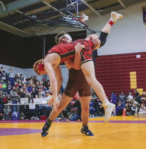 Nathan Hubsch of Webster Area Bearcats picks up Hayden Landmark of Deuel/Deubrook Area Cardinals during their match at SDHSAA Region 1B boys tournament Feb. 21 in Webster. Hubsch won the match by fall in 2:26 and went on to place fourth in the 175 weight class. Reporter &amp; Farmer | Leyton Beardslee