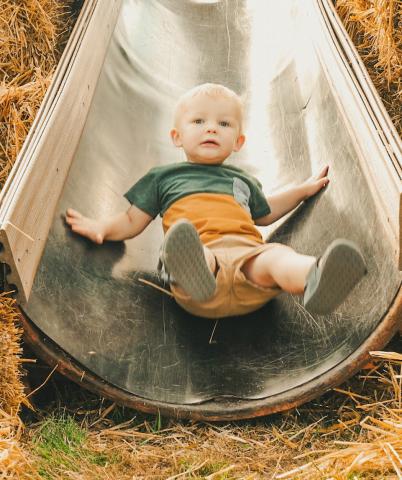 Fisher Kimble, age one, rides down a slide during Pumpkin Fest in Webster Oct. 4. He is the son of Huxley and Kali Kimbol from Watertown. Reporter &amp; Farmer | Leyton Beardslee