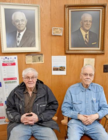 Hansmeier brothers Keith and Floyd sit beneath portraits of their grandfather Henry and father Ralph in the office of Hansmeier &amp; Son, Inc. in Bristol.