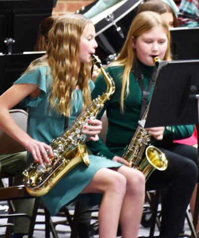 As a part of the sixth grade band’s performance in the winter concert Dec. 9 a multitude of musical presentations were on display. From left Portlyn Johnson and Karley Lone play the saxophone during the concert. Reporter &amp; Farmer | Brenner Cariveau