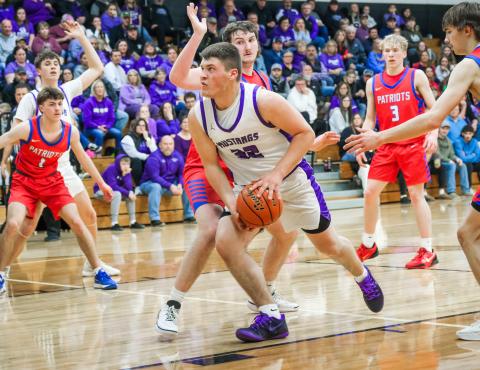 Tripp Gaikowski of Waubay/Summit Mustangs drives towards the hoop through defenders during their 51-36 victory over Hitchcock-Tulare Patriots in the Region 1B quarterfinals March 3 in Waubay. Gaikowski totaled six points in the win and the Mustangs advanced to take on Leola/Frederick Titans March 6 which was not completed in time for results to be published. Reporter &amp; Farmer | Leyton Beardslee