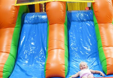 As Germanfest was celebrated Sept. 28, attendees inside the armory could purchase items from vendors, get drinks, and food The children had two different bouncy houses to play on. Here, three-year-old Webster native Lucy Spears, slides down one of the bouncy house slides with her mother Megan watching in the background. Reporter &amp; Farmer | Brenner Cariveau
