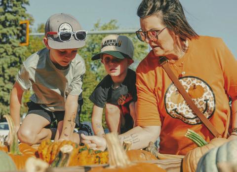 From left, Holden Martin, seven, Layton Martin, three and their grandmother Patti Martin, Webster, pick out pumpkins during Pumpkin Fest in Webster Oct. 4. This year marked the 26th anniversary for the annual festival. Reporter &amp; Farmer | Leyton Beardslee