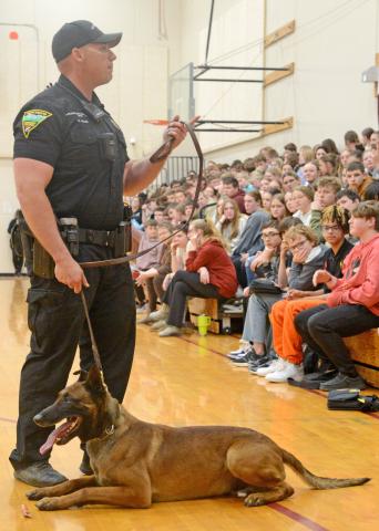 Members of the South Dakota Highway Patrol were at Webster Area High School April 23 to answer questions and hold a demonstration of the drug sniffing dog named Murph, a six-year-old Belgian Malinois. Here, handler Trooper Brandon Miller stands before the assembly of youth answering questions related to his line of work. Both Miller and Murph are from Webster. Reporter &amp; Farmer | Amanda Dulitz